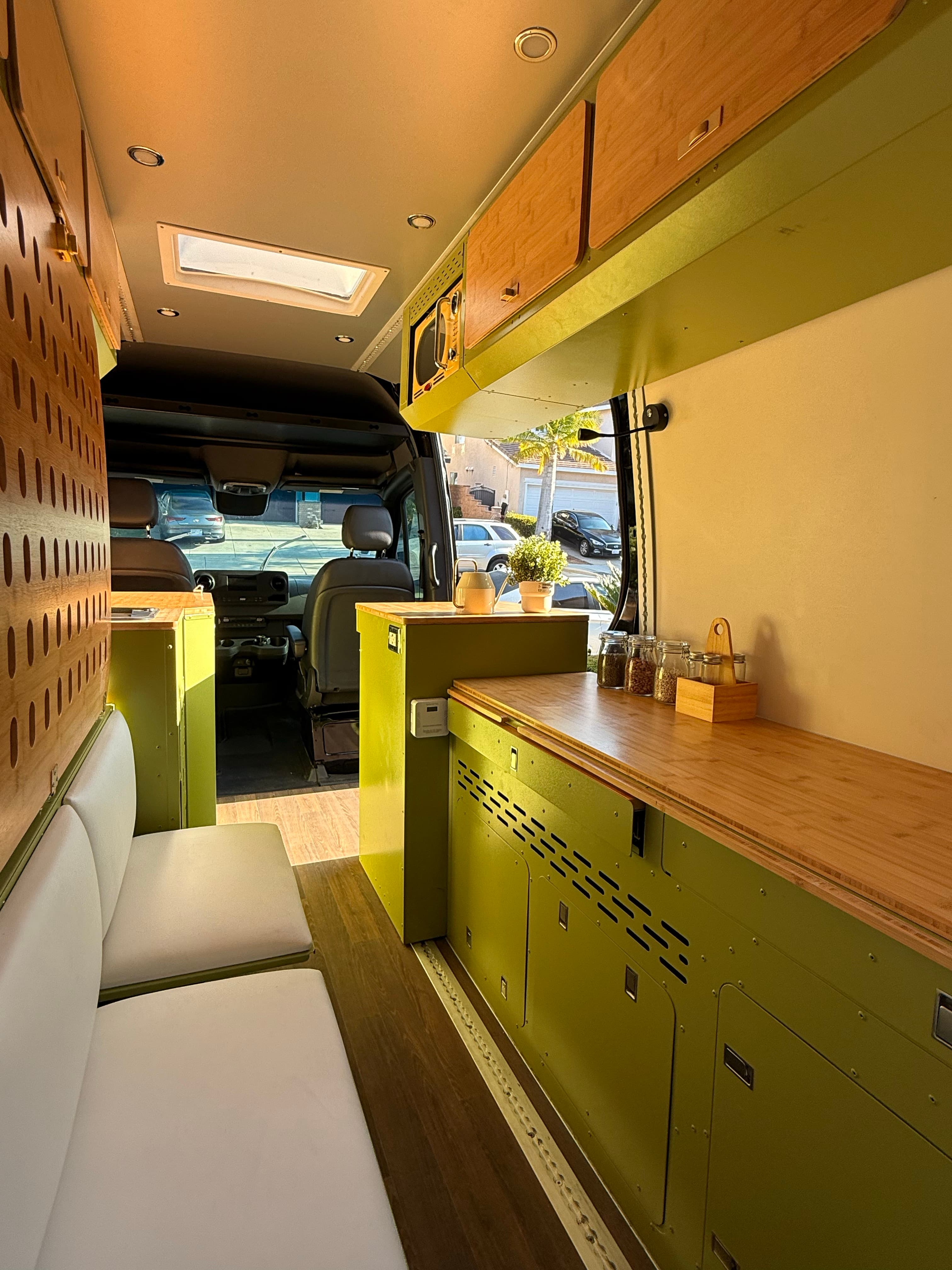 Finished camper van galley and front cabin view