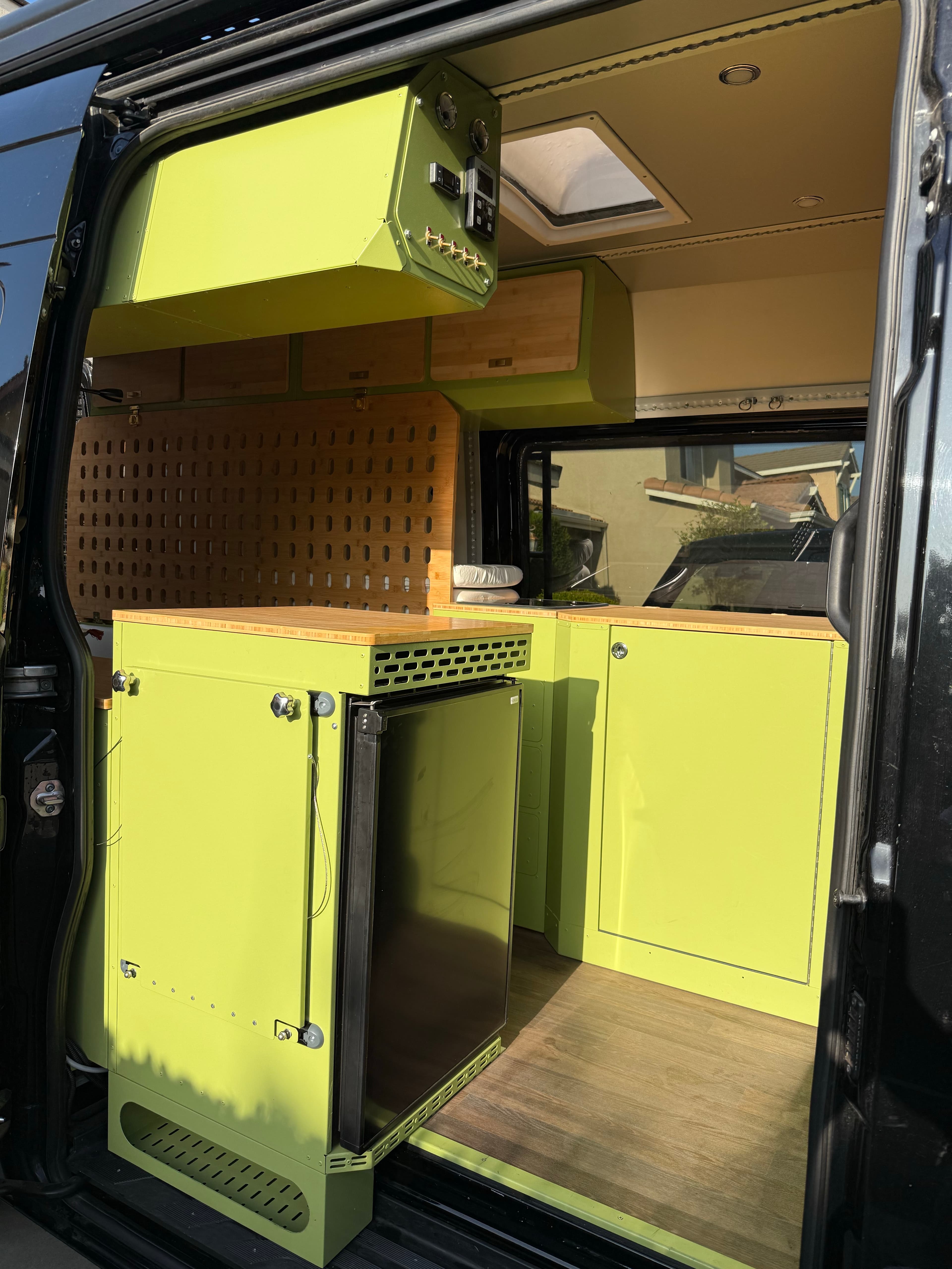 Finished camper van rear storage and cabinet view